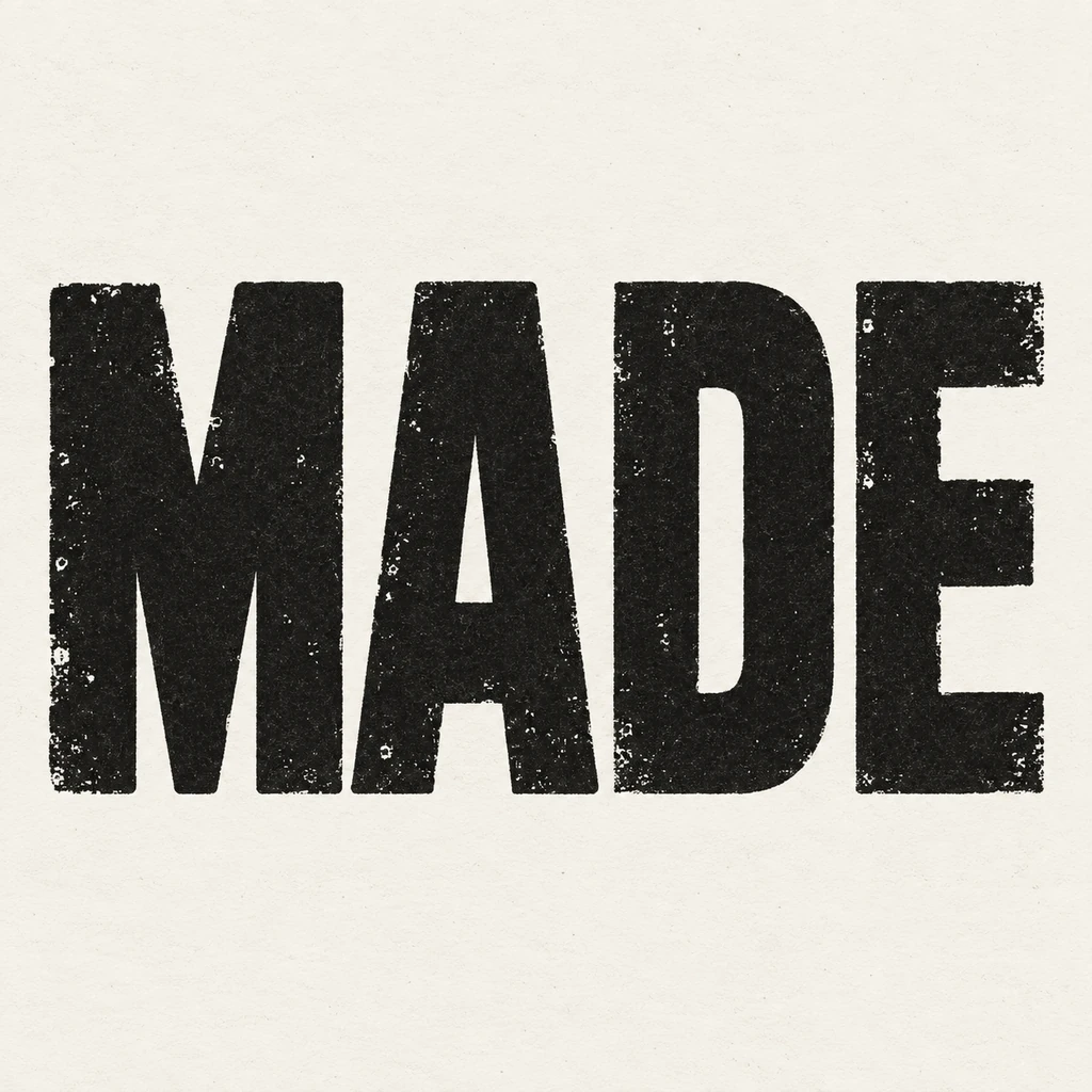 MADE in complete near-black block capitals with controlled ink wear on warm off-white paper
